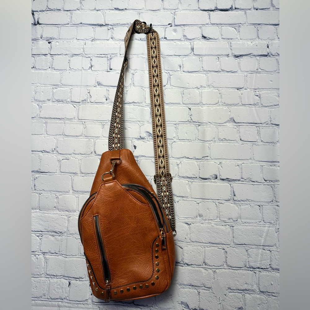 Adorable brown slingshot bag with removable strap and lots of pockets